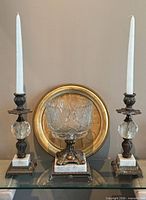 Group shot of both candlesticks flanking cut glass compote with Italian tray behind