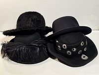 Group shot of four black hats showing overall styles and trims