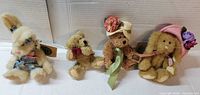 Group of three plush animals with tags displayed upright