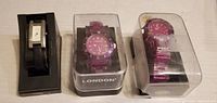 Three boxed wristwatches side by side