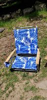 Front view of open chair showing pattern, armrests and fabric tear