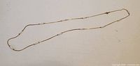 Full view of the entire necklace laid out straight showing bead spacing and clasp
