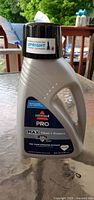 Front view of sealed 48 fl oz Bissell Pro Max Clean + Protect carpet cleaner bottle