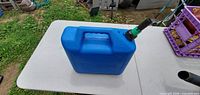 Front view of blue 5-gallon kerosene container on table