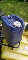 Full view of blue 5-gal water jug showing large screw cap and molded handle
