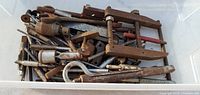 Overhead view of entire bin with assorted metal taps, clamps, and hardware
