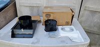 Box marked Broan Model 509 with fan sleeve, fan assembly, grille, hardware visible