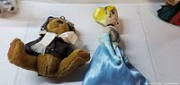 Cinderella plush doll and aviator teddy bear side by side