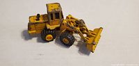 Left side view showing loader bucket, 544G marking, articulation joint, tyre detail