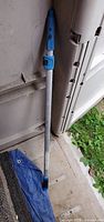 Full view of telescopic aluminum pole with blue plastic components