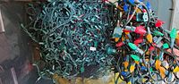 Top view of tote showing tangled green-wire light strands with multicolour bulbs