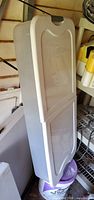 Full view of plastic underbed storage box standing upright