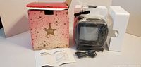 Portable TV with power cord, manual, styrofoam inserts and retail box
