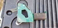 Left side view of tape dispenser showing handle, frame opening and blade guard