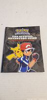 Front cover showing title, Ash, Pikachu