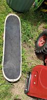 Top view of snow boogie board showing black grip surface and white edge