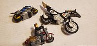 All three toy motorcycles grouped on white background