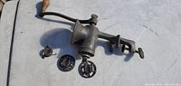 Full view of grinder with handle, clamp, two cutting discs and collar ring