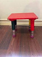 Full view of stool front and side showing design and wear