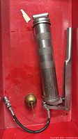 Grease gun and oil can in drawer