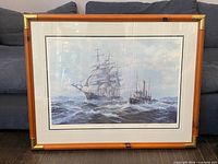 Front view of framed print showing artwork, matting, and frame