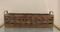 full frontal view of wooden slat basket showing overall shape and construction