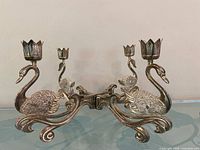 Full view of silver plated swan candelabra showing four arms and candle cups