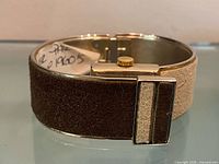 Side/back view showing brown suede exterior and hinge
