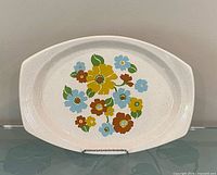 Front view of oval stoneware platter showing full floral pattern
