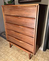 Front view of walnut Princeville five-drawer tall dresser