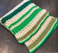 Folded crochet afghan showing overall striped design