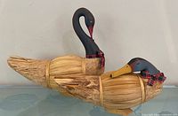Two corn husk swan figurines side view showing bodies and heads