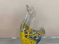Left profile of glass goose and gosling showing colourful interior