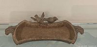 Top view of cast iron bird bath showing full shape and bird figures