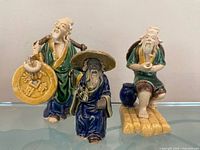 Front view of three Shiwan mudmen figurines
