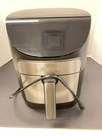 Front view showing Gourmia logo, handle, power cord