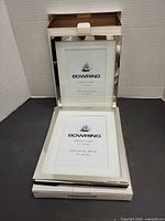 Two Bowring frames inside open boxes