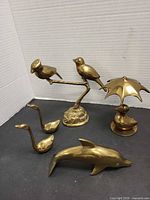 Group shot of all five brass figures