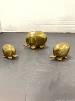 Three brass elephants grouped to show size and design