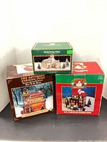 Three boxed Christmas village building sets