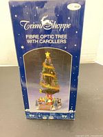 Retail box showing Trim Shoppe Fibre Optic Tree With Carolers branding