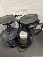 Full set showing three bowls with lids and power pod