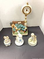 Group of four porcelain music box figurines