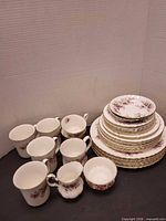 Group shot of stacked plates, cups and mugs showing pattern and quantity