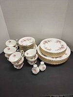 Full set showing plates, cups, saucers and bud vases