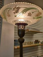 Pressed glass floral torchiere shade on lamp lit