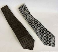 Full view of both neckties side by side showing patterns