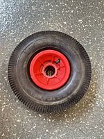 Front view of the replacement wheel showing tread, hub, and valve