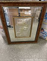 Full view of framed sterling silver art with wood frame