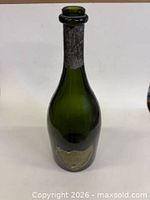 Full view of green glass bottle